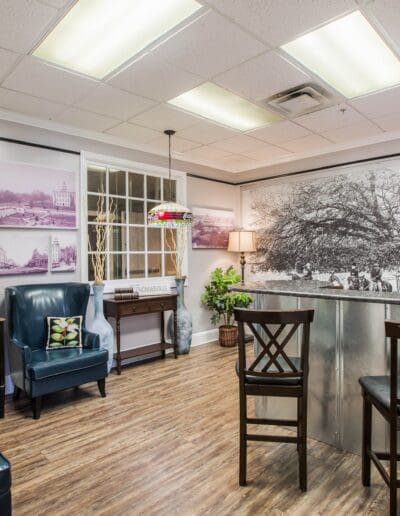Indoor lobby designed to resemble a street with storefronts, table and chairs, and lamp posts